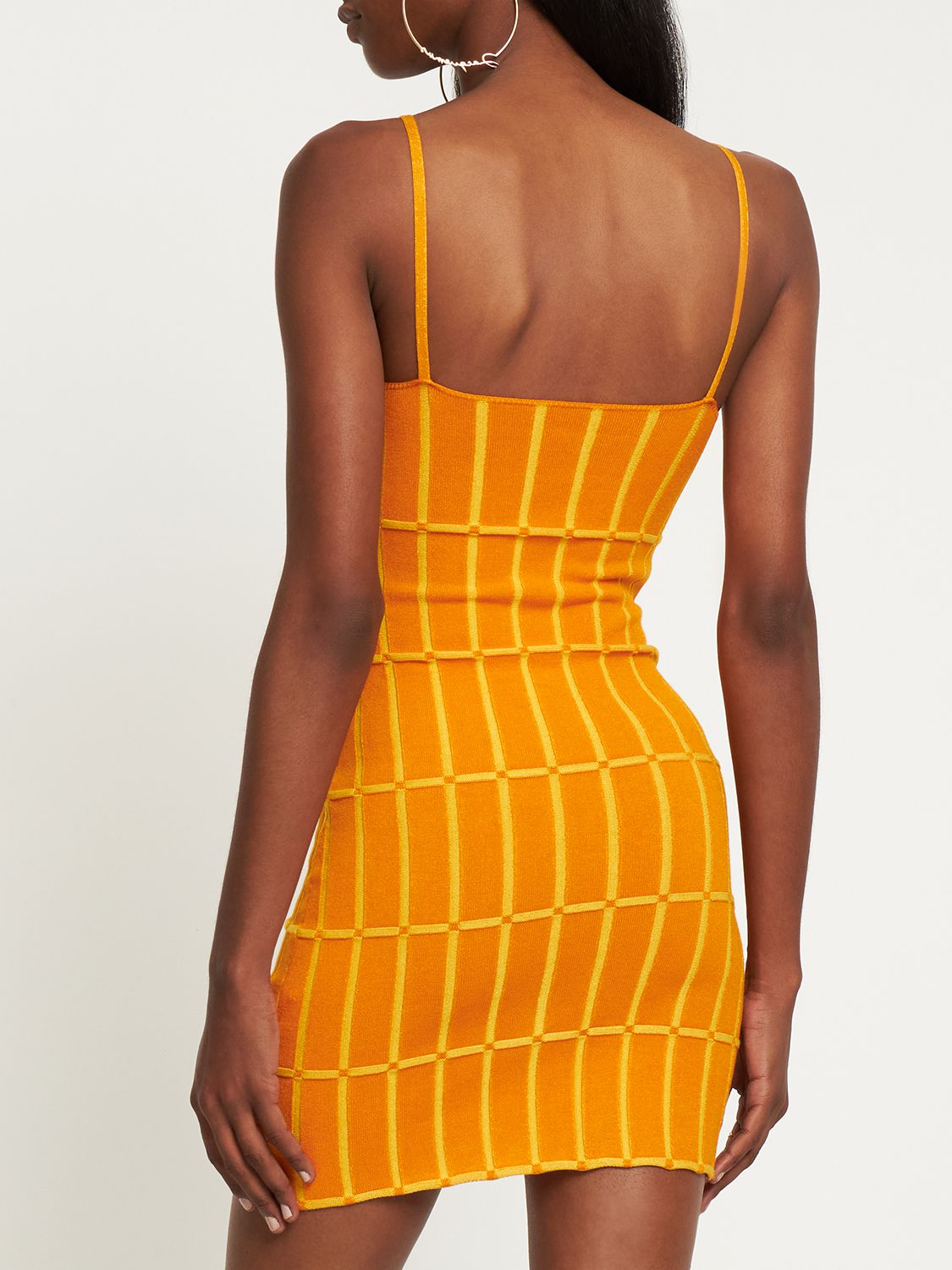 Fitted orange dress with vertical pattern