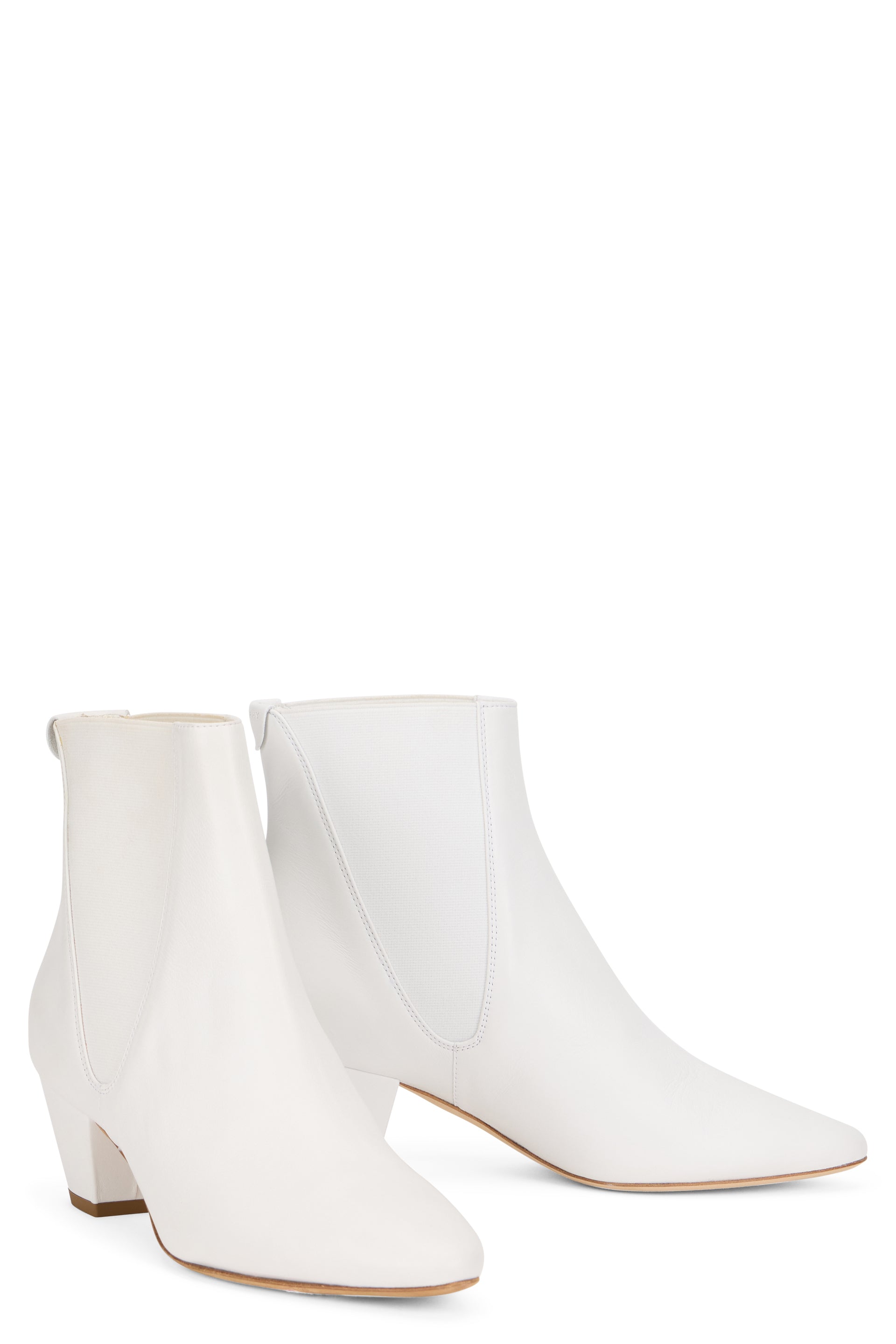 White ankle boot with elastic insert and low heel.