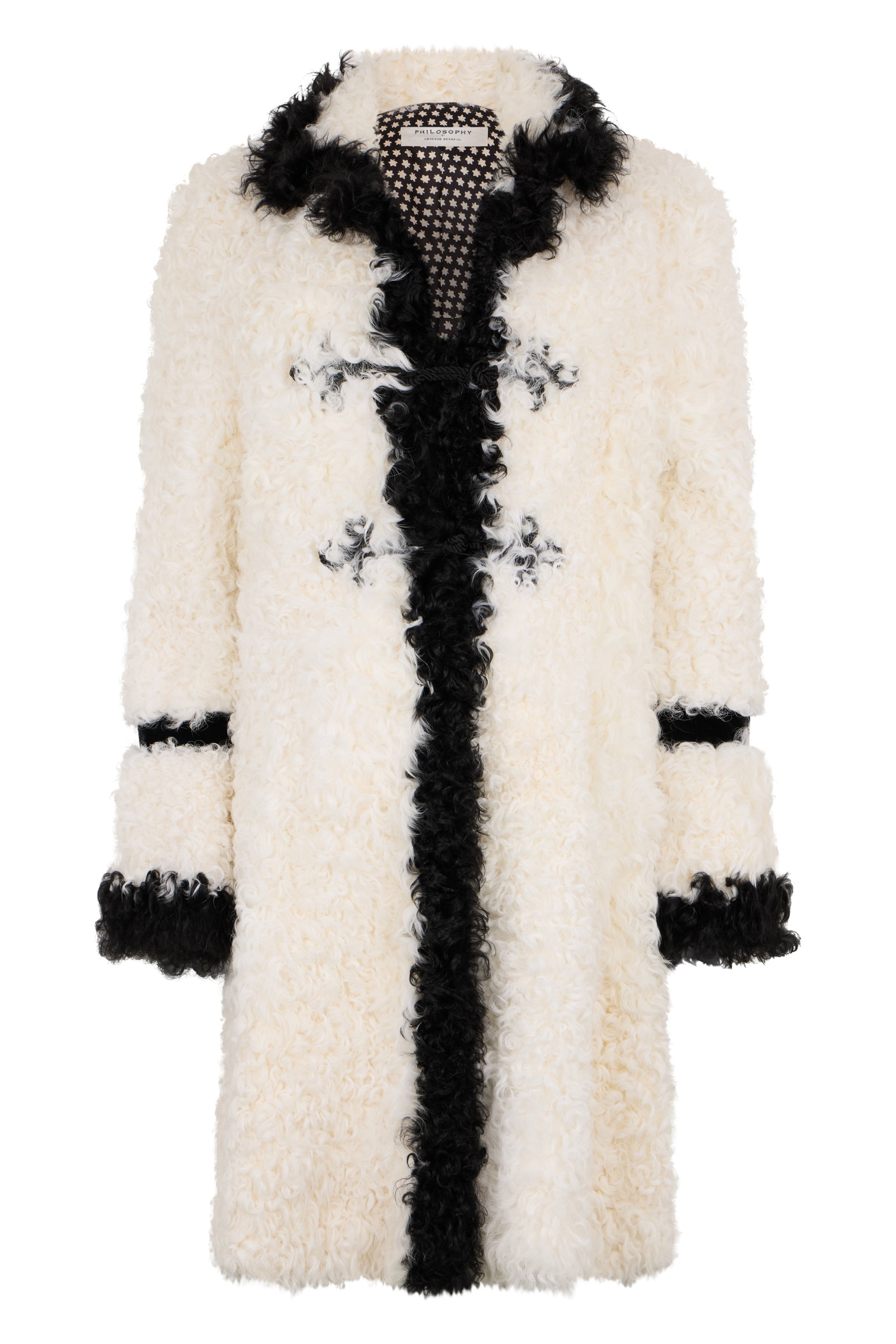 Long coat in white fur with black details.