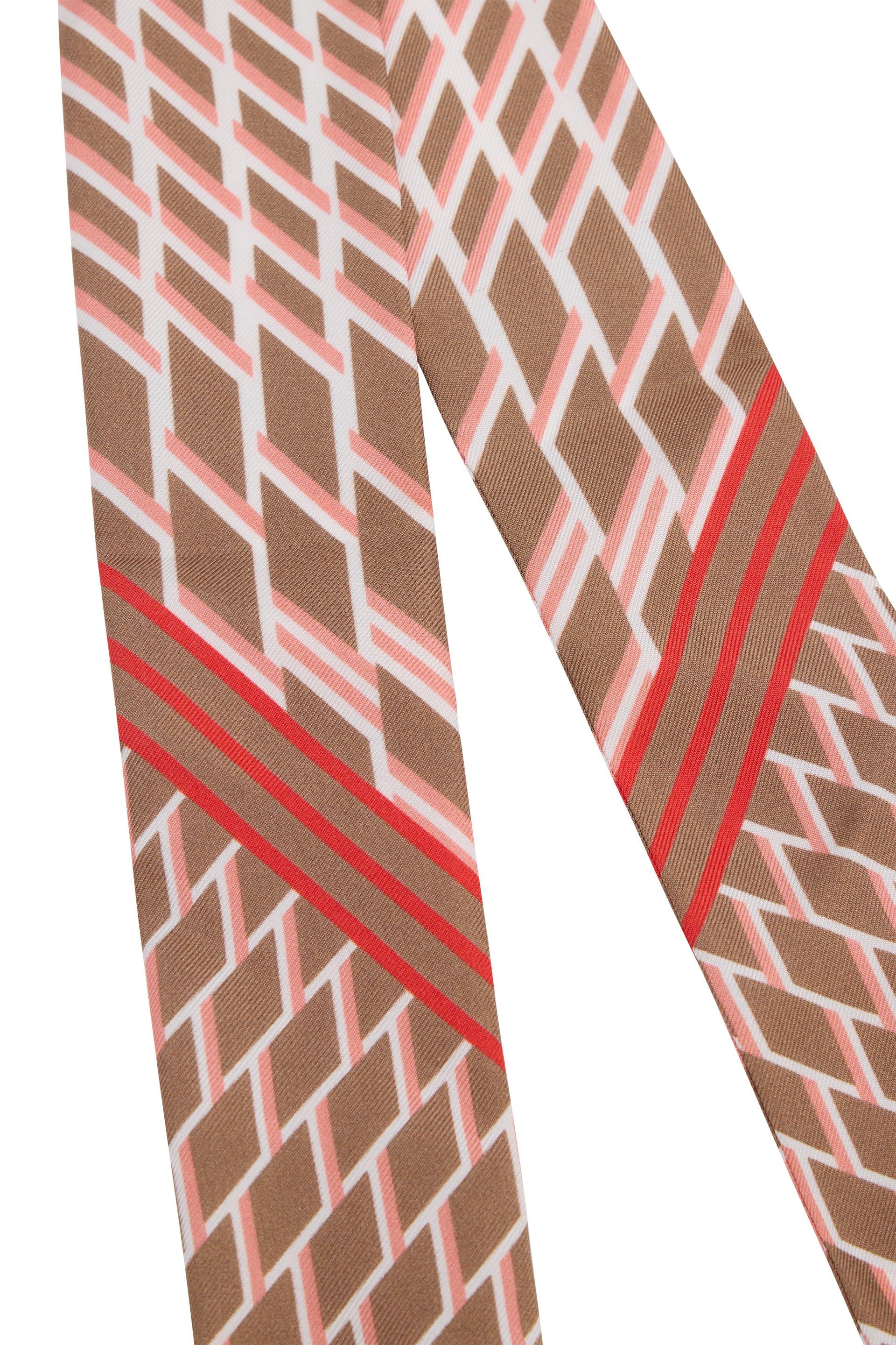 Scarf in camel tones with contrasting geometric pattern.
