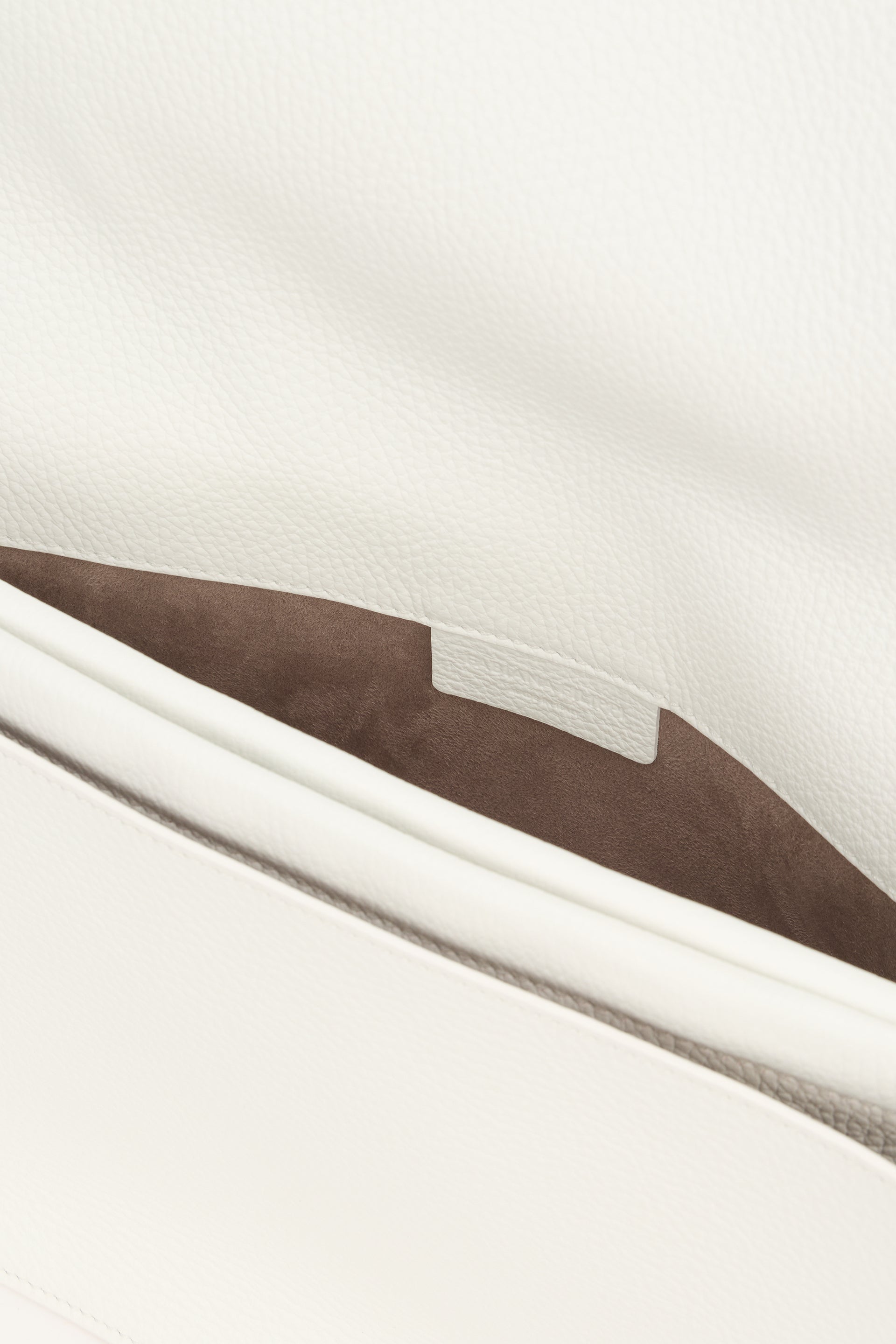 Elegant white bag with refined handle.