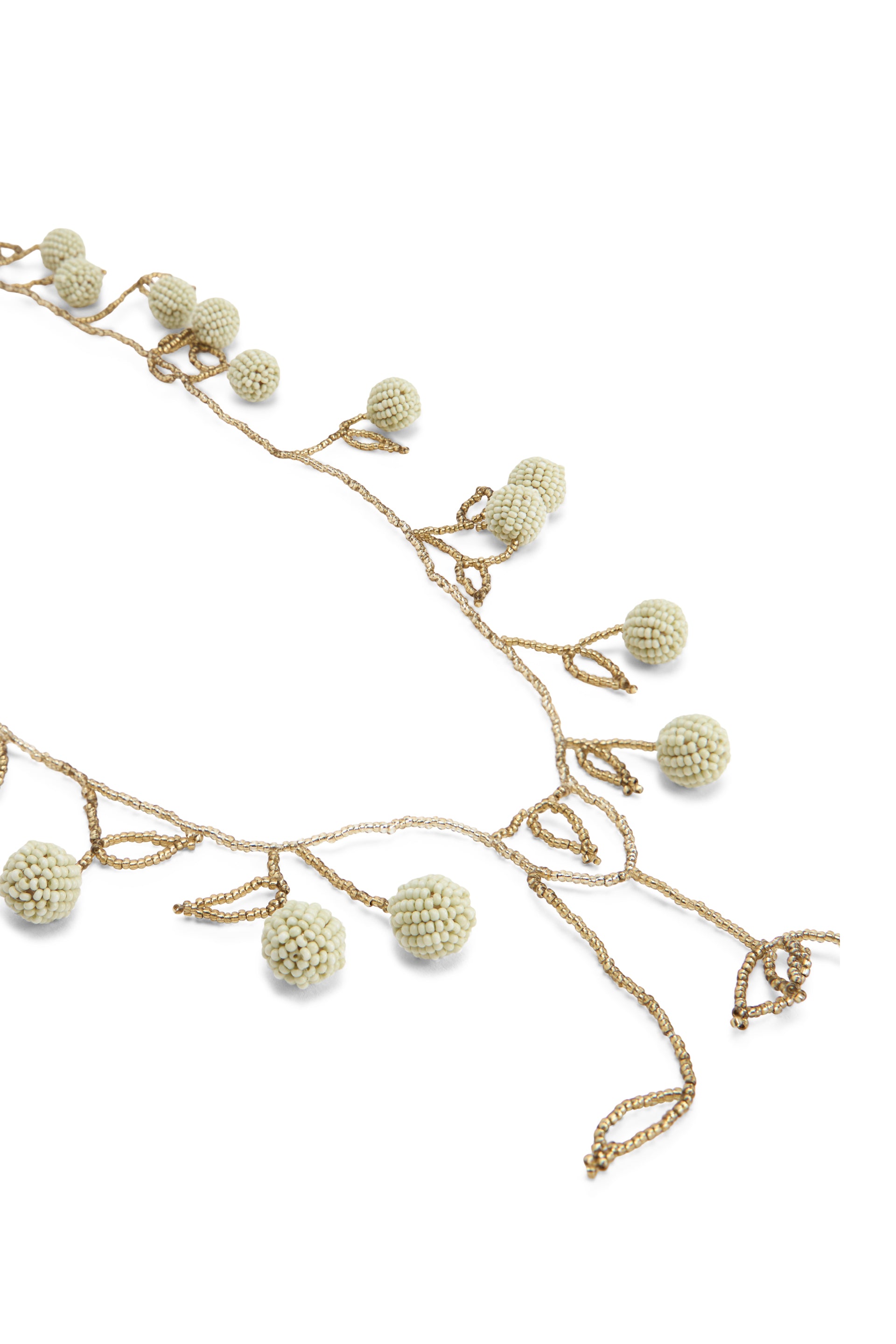 Elegant beige necklace with pendants and beads in the shape of a leaf.