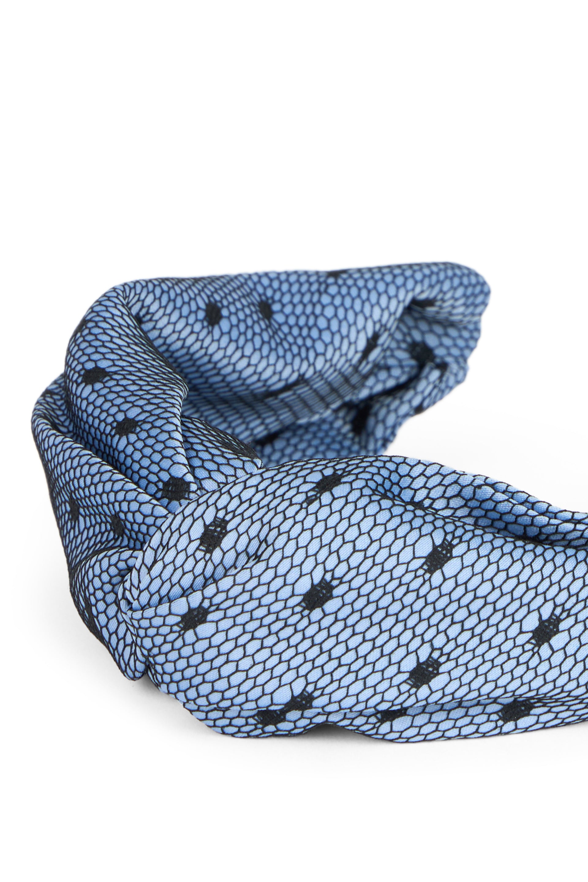 Blue headband with mesh pattern and black dots.