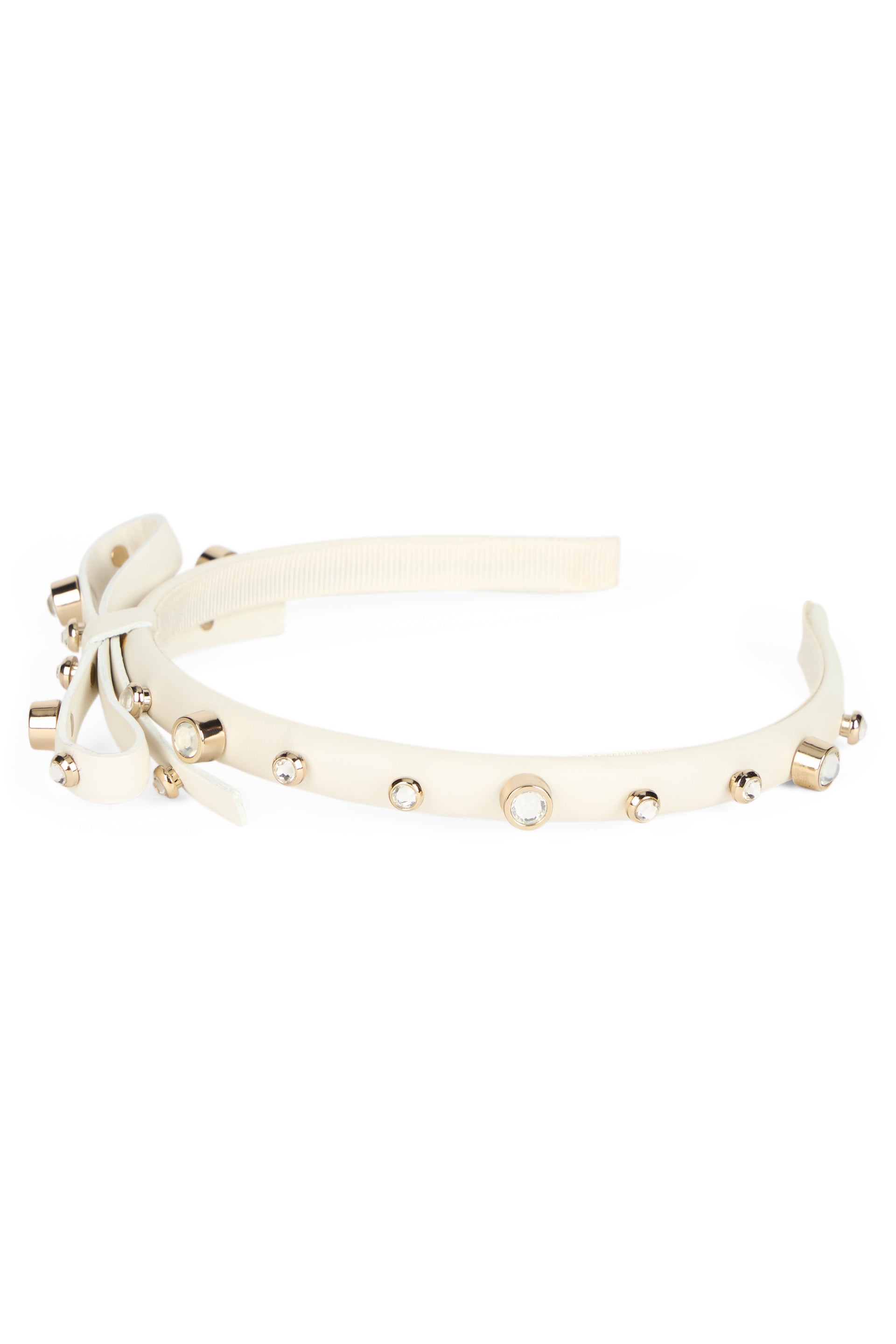 Cream color headband with bow and decorative studs.