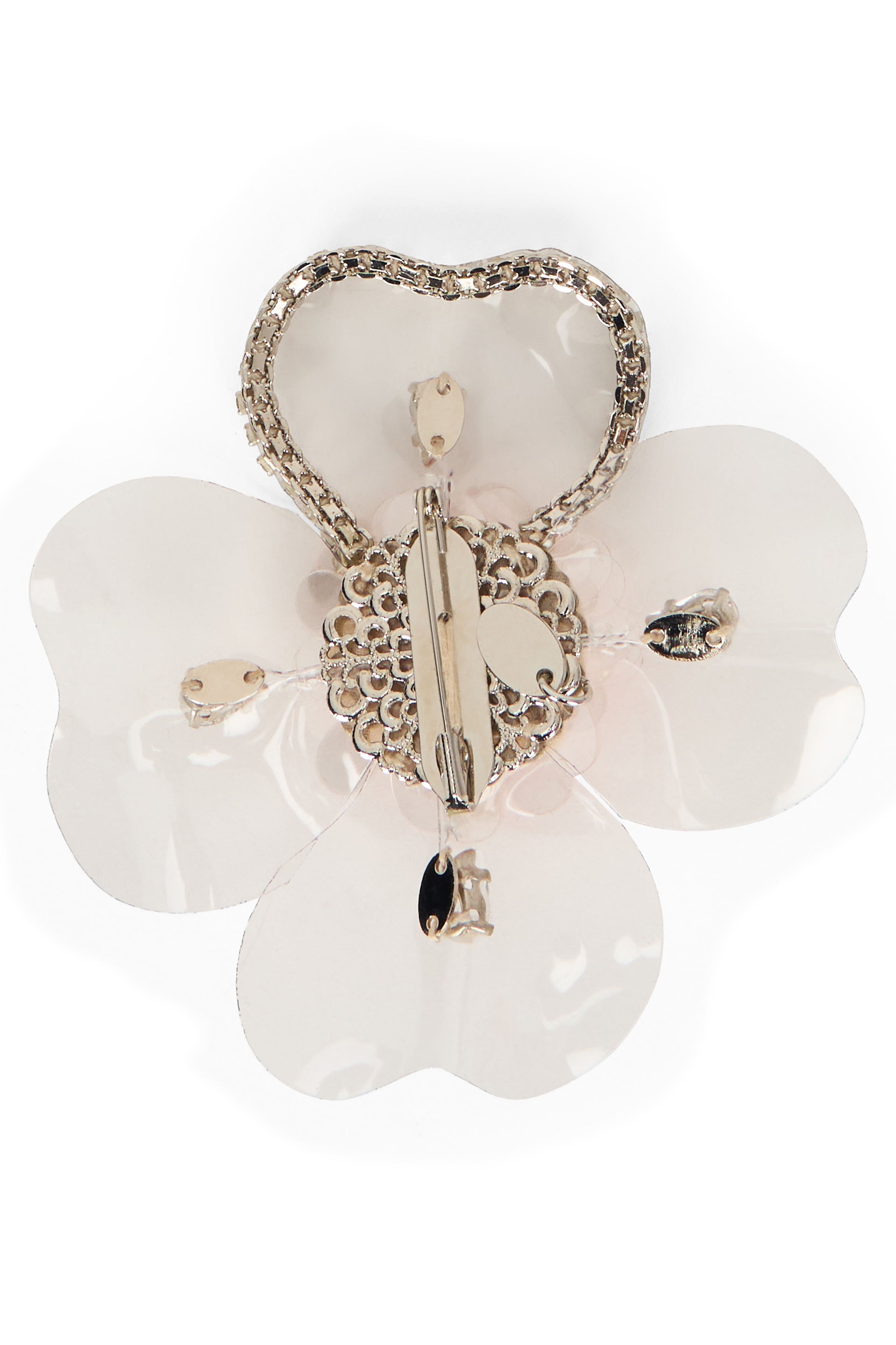 Flower-shaped brooch with white petals.