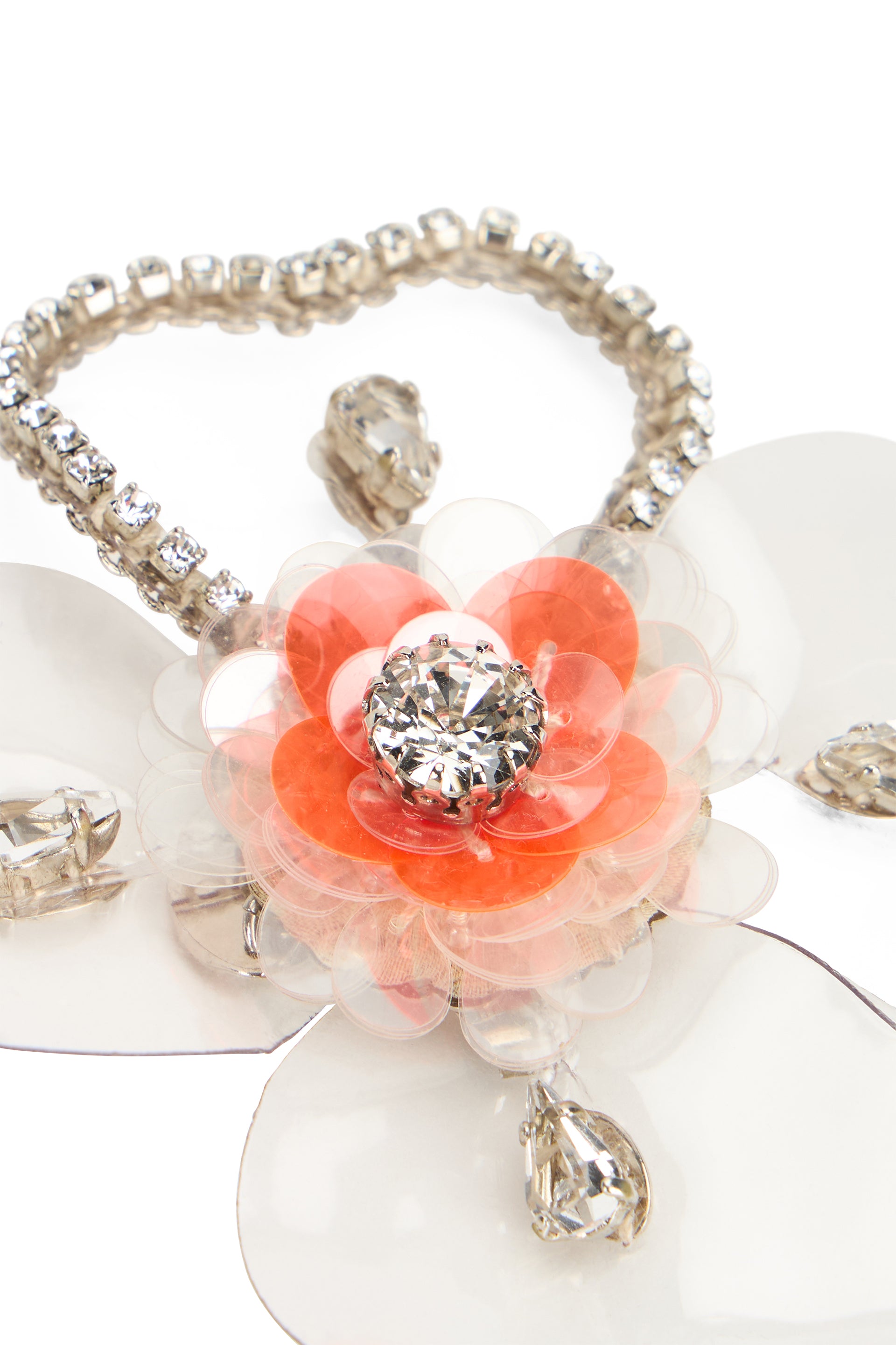 Flower-shaped brooch with white petals.