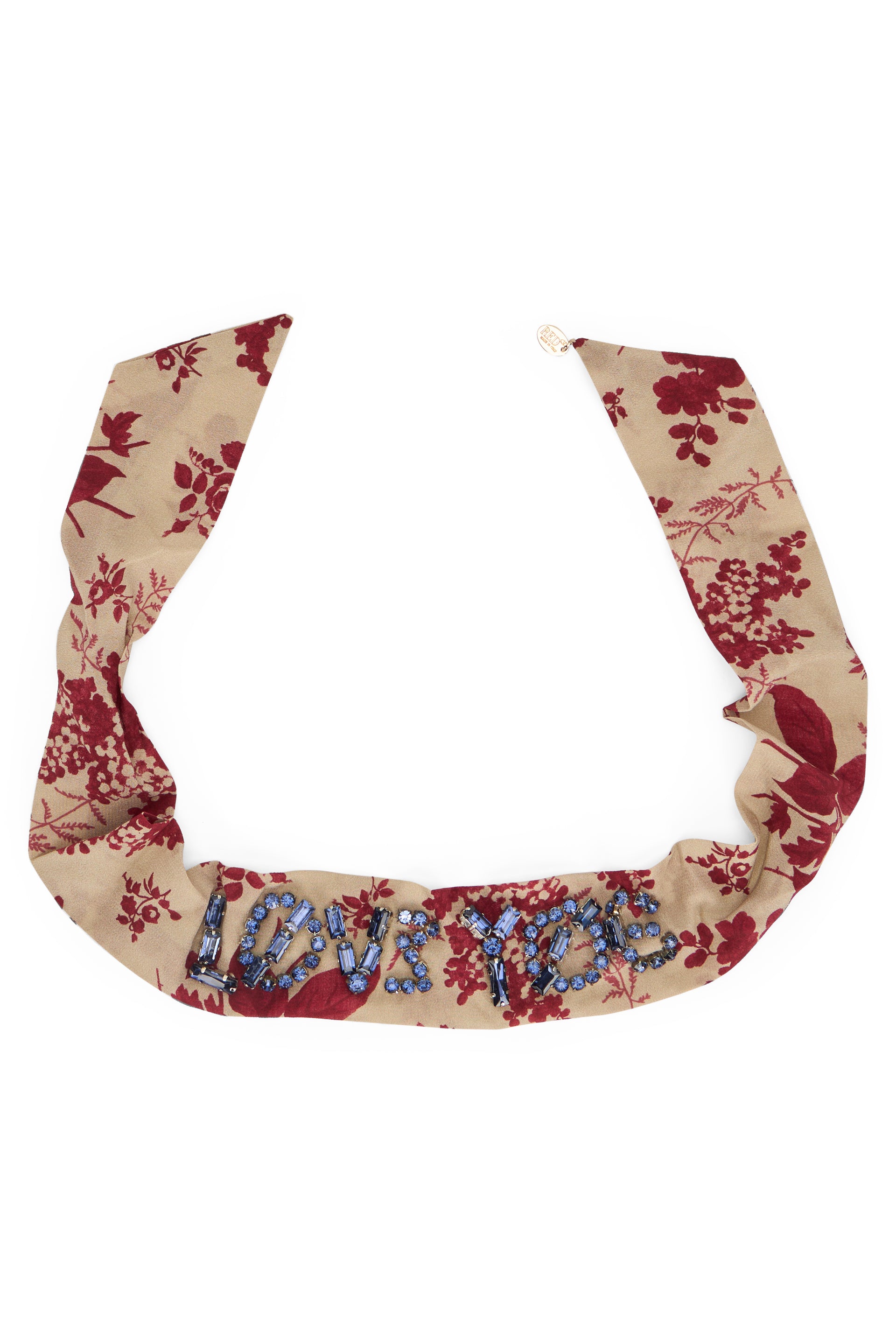 Beige headband with floral pattern in elegant and versatile fabric.