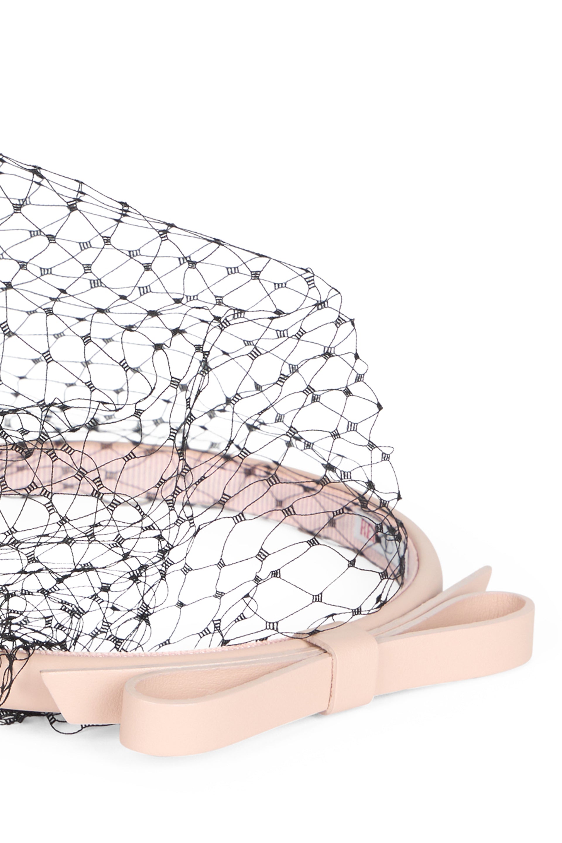 Beige headband with black net.
