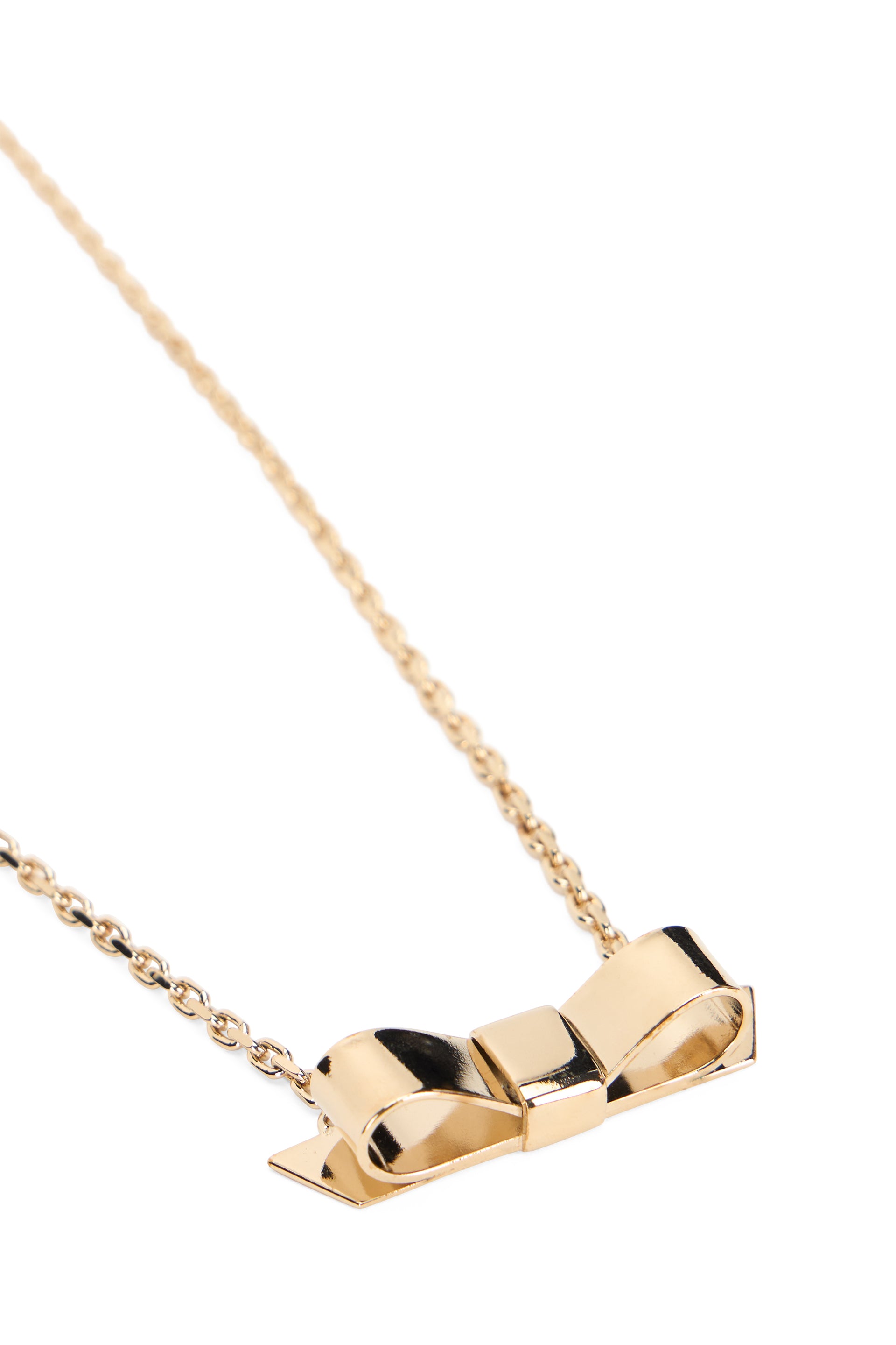 Elegant gold necklace with a delicate and minimalist pendant in the shape of a bow.