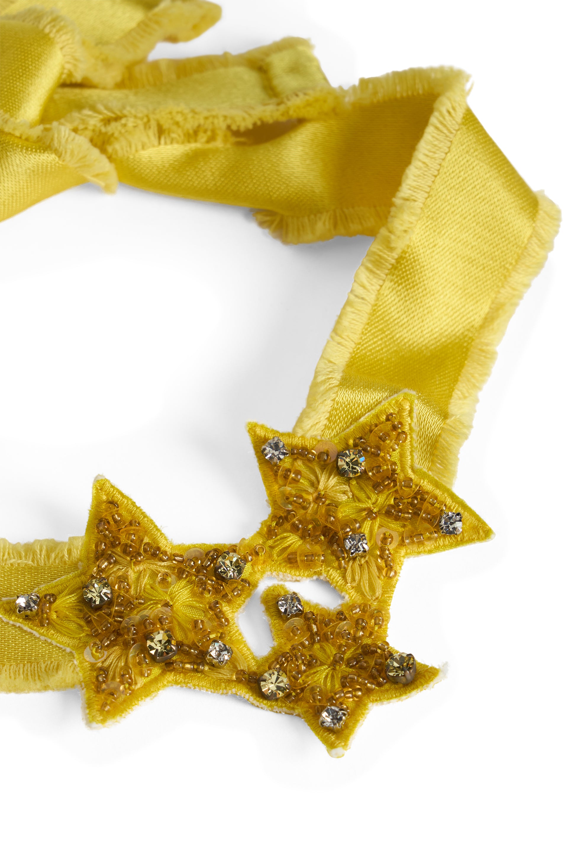 Elegant necklace in mustard color with decorative stars.