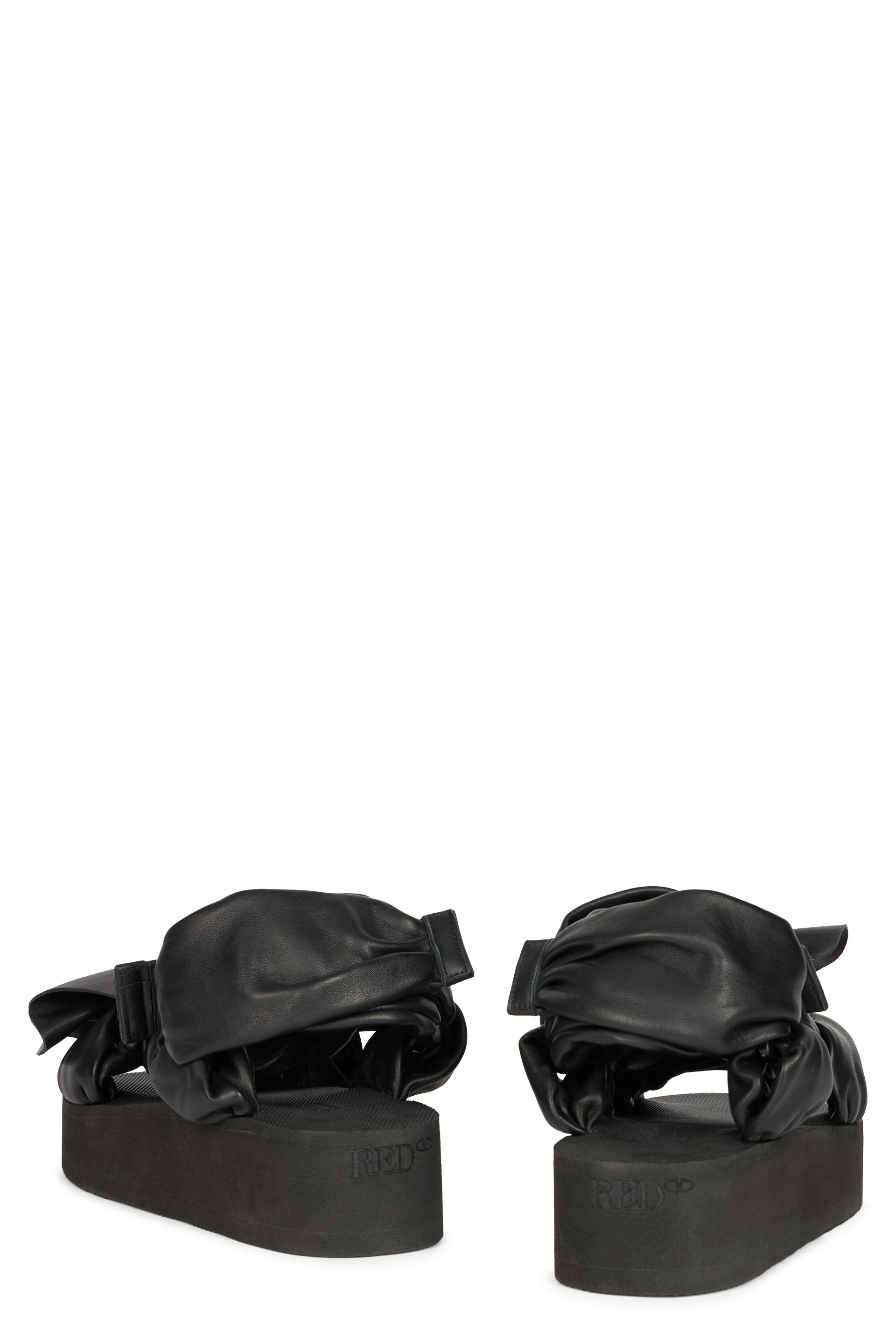 Black sandals with braided details and platform.