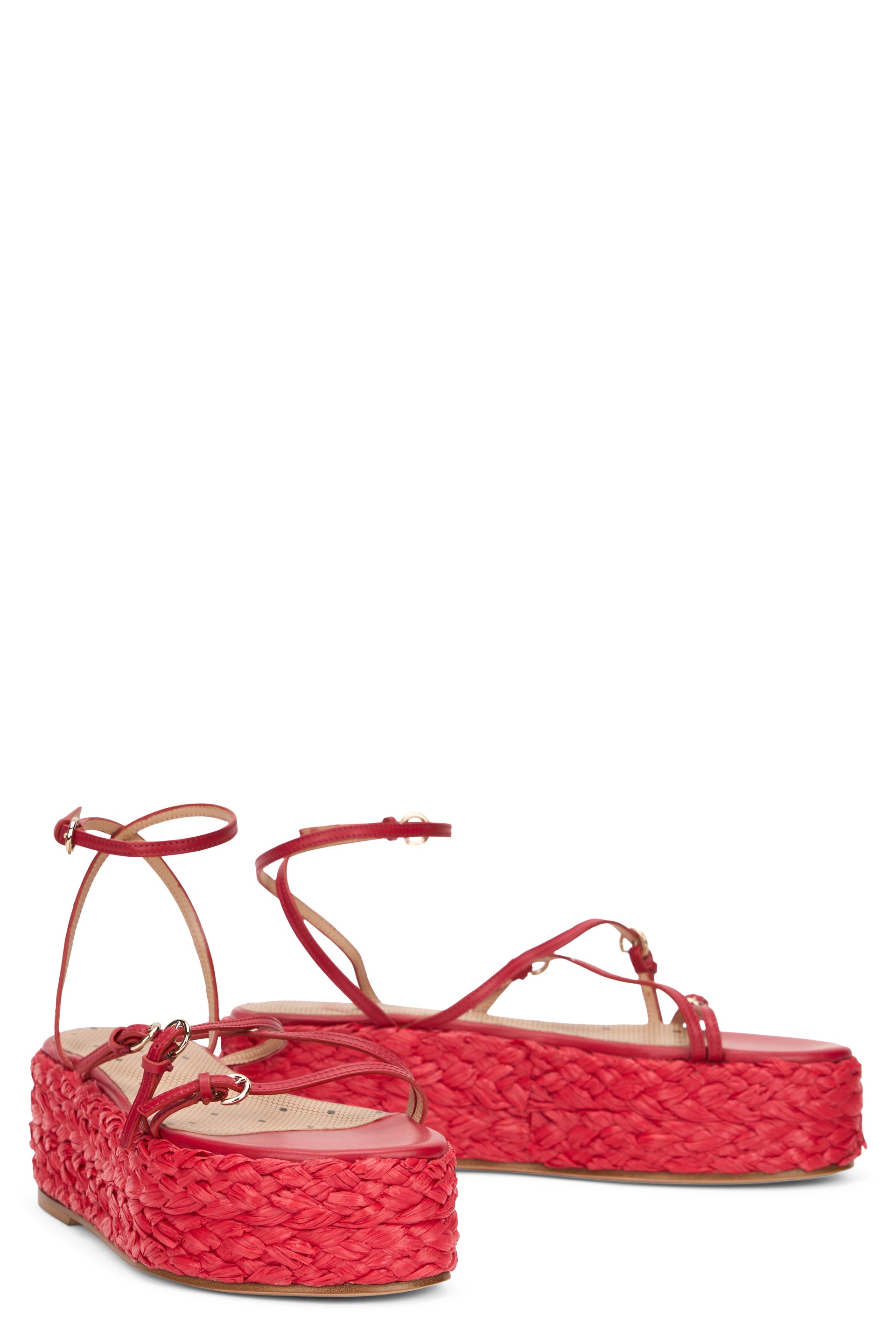 Red platform sandals with thin straps.
