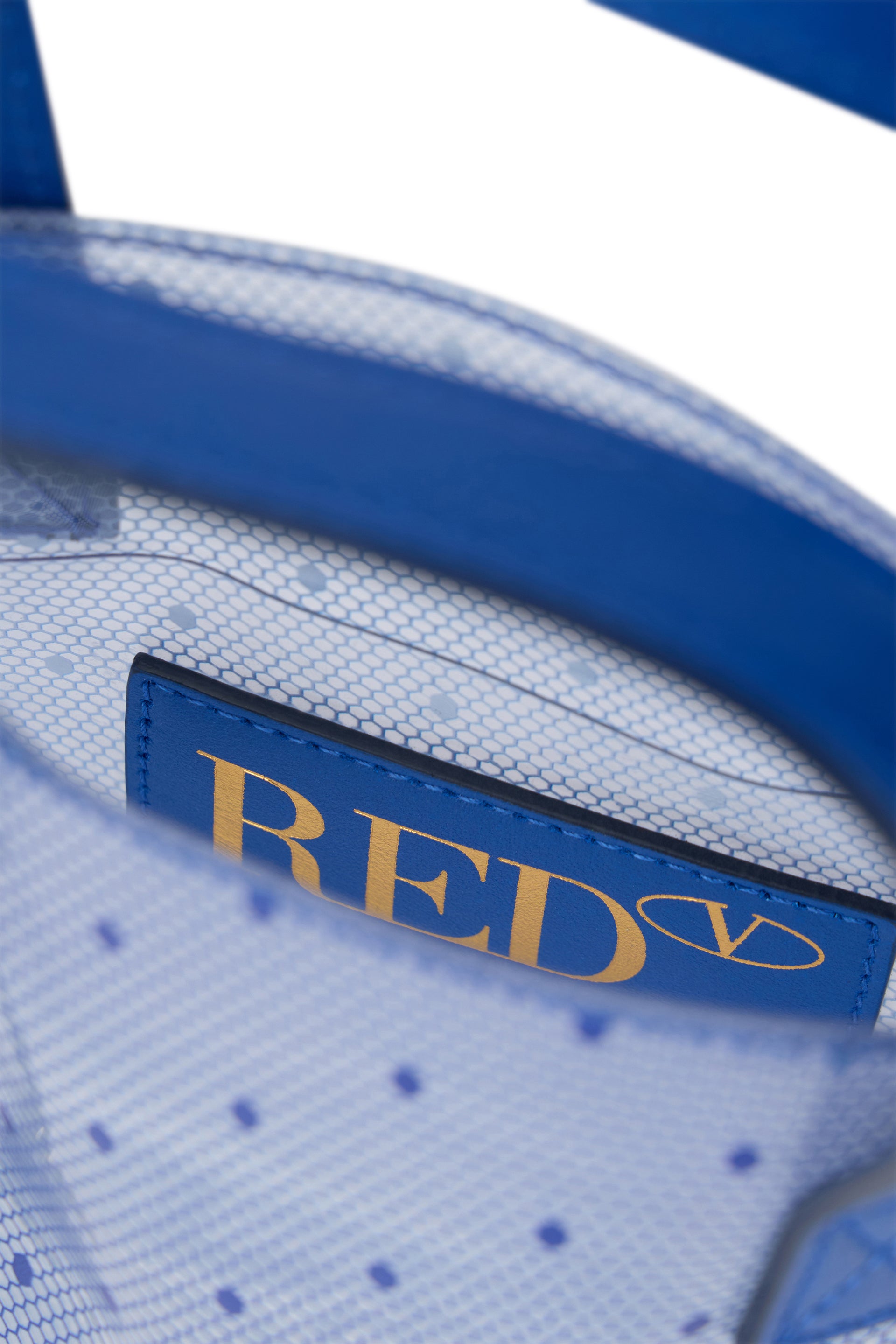 Transparent tote bag with details and blue dots.