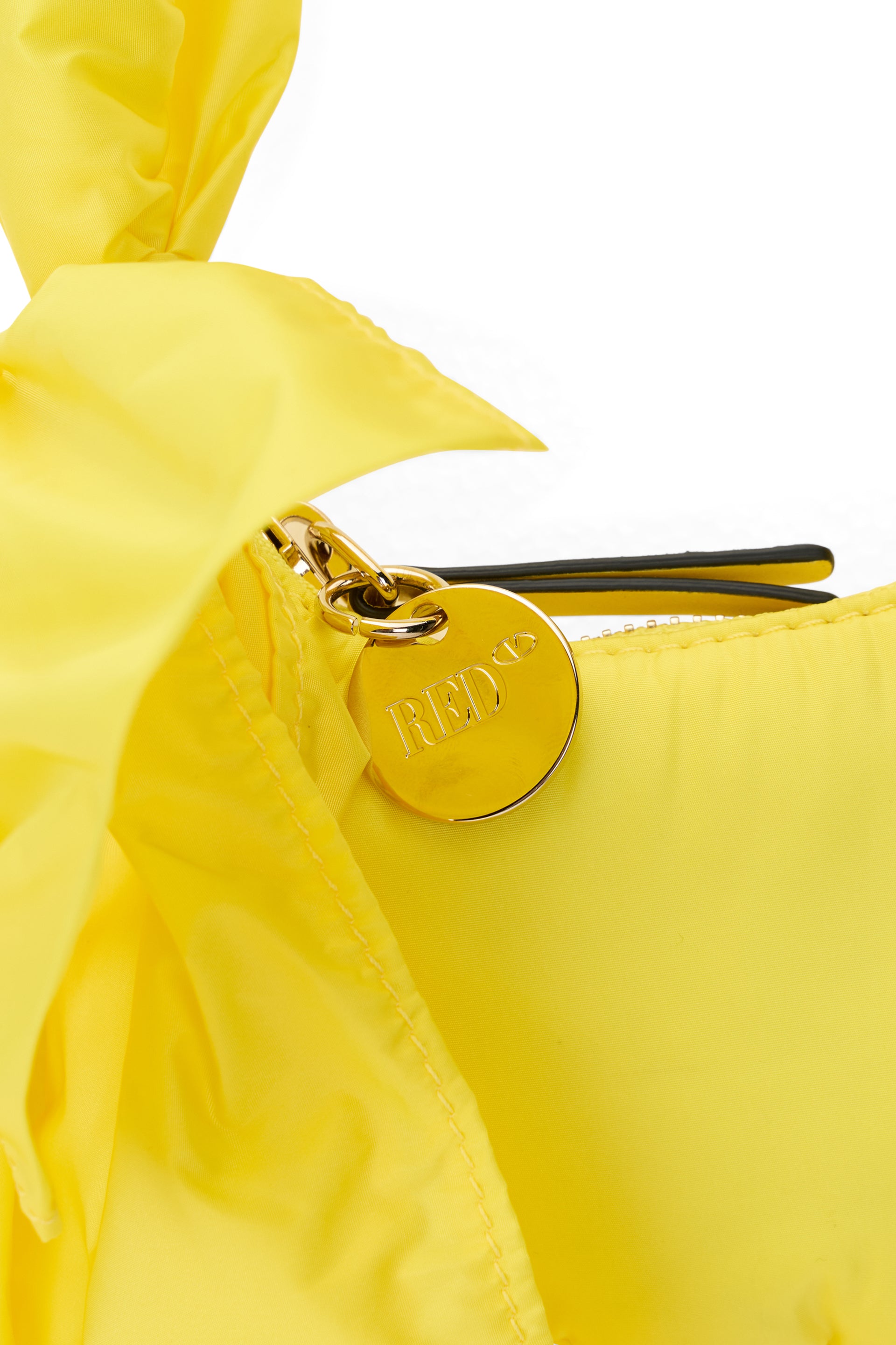 Elegant small yellow pouch with decorative bow.