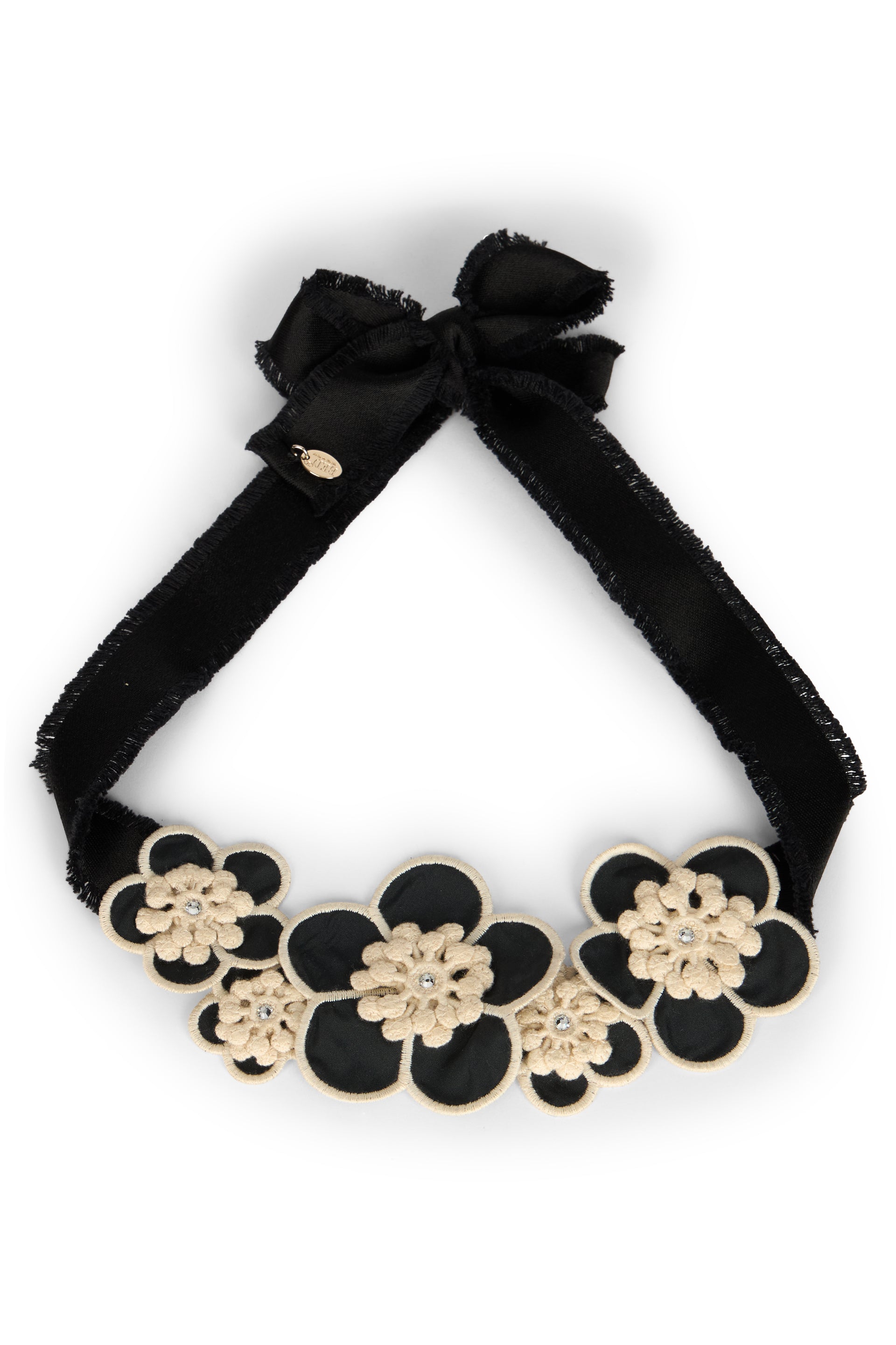 Elegant floral necklace with black ribbon and contrasting beige elements.