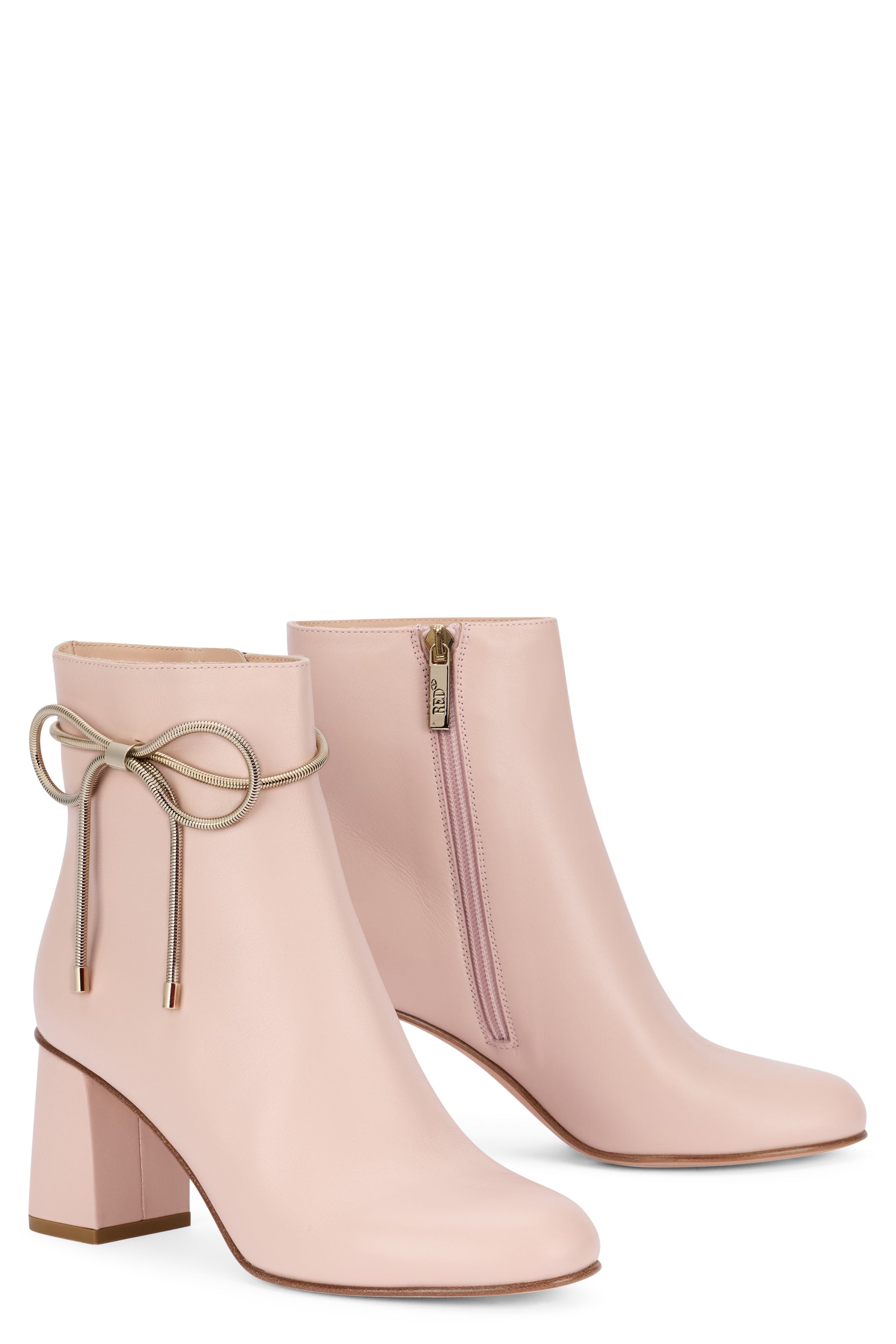 Ankle boots in pale pink color with mid heel.