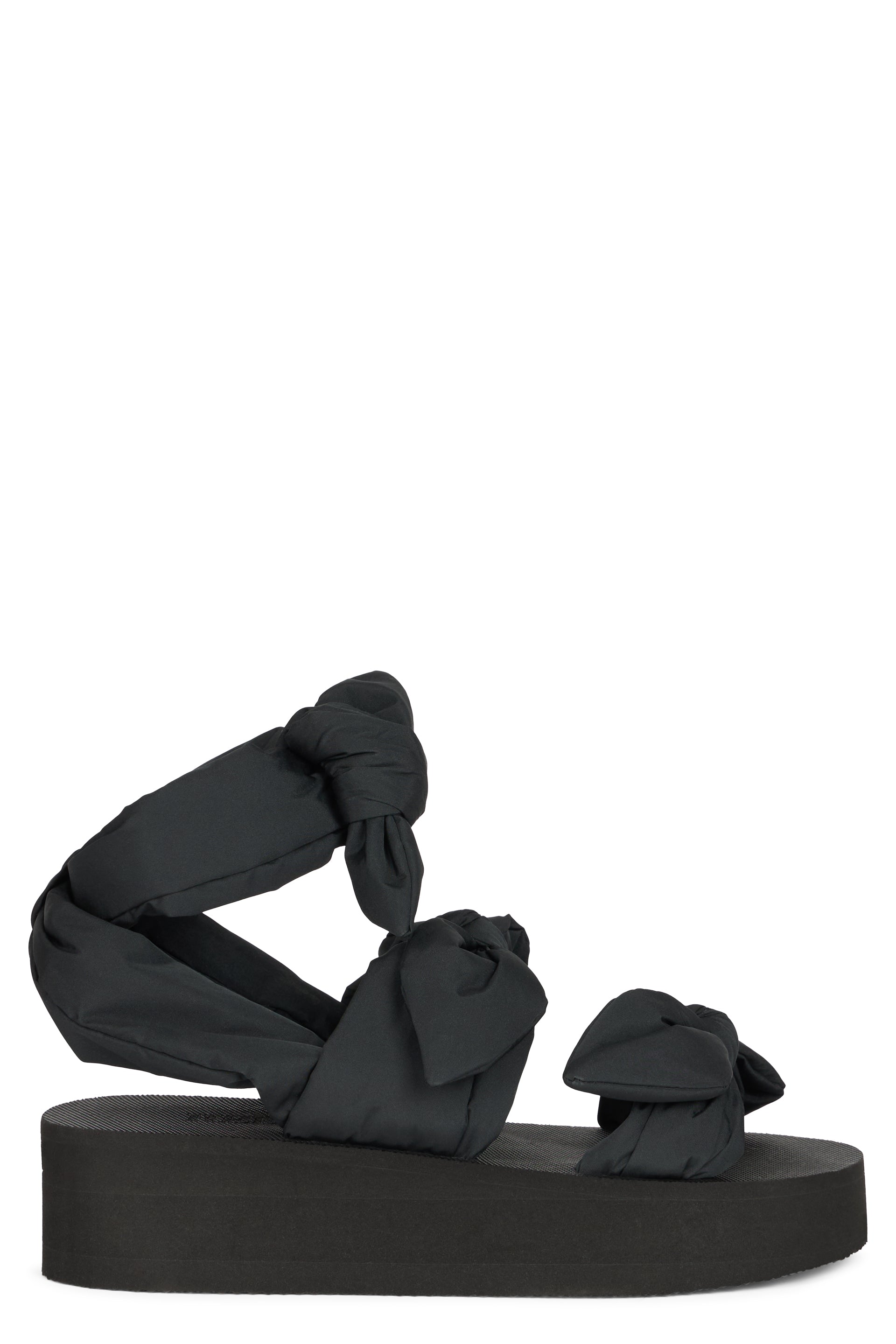 Modern black sandal with platform and wraparound strap.