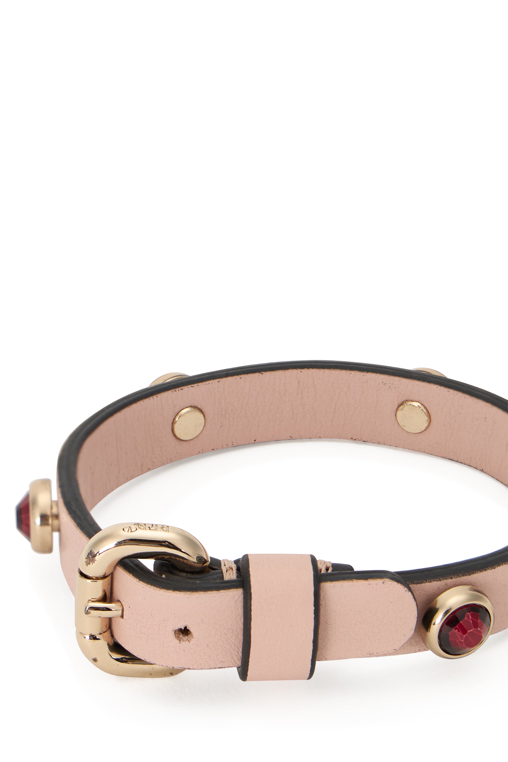 Elegant golden pink bracelet with decorative gems.