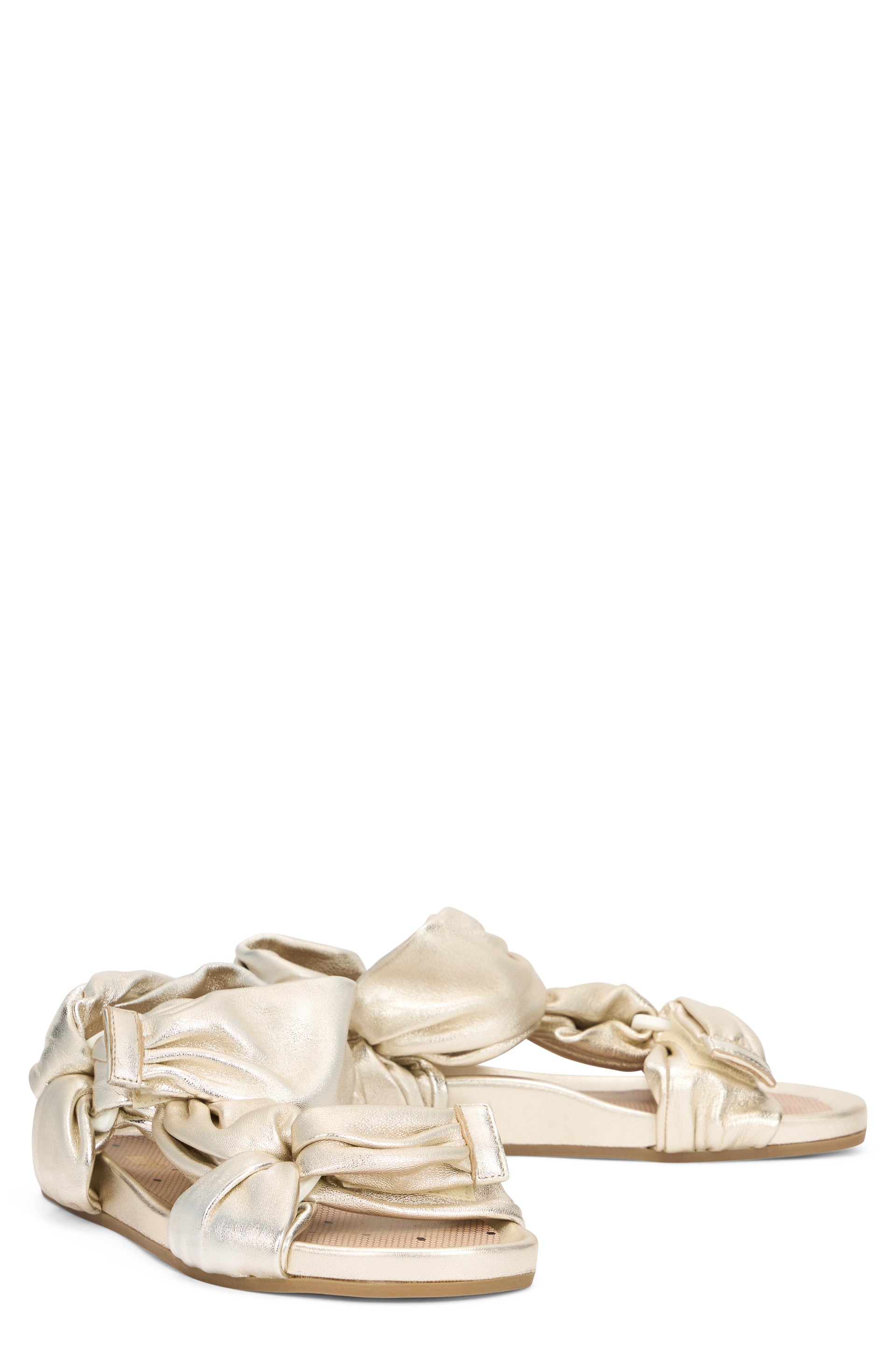 Light sandals in gold color with a low sole and modern, versatile design.