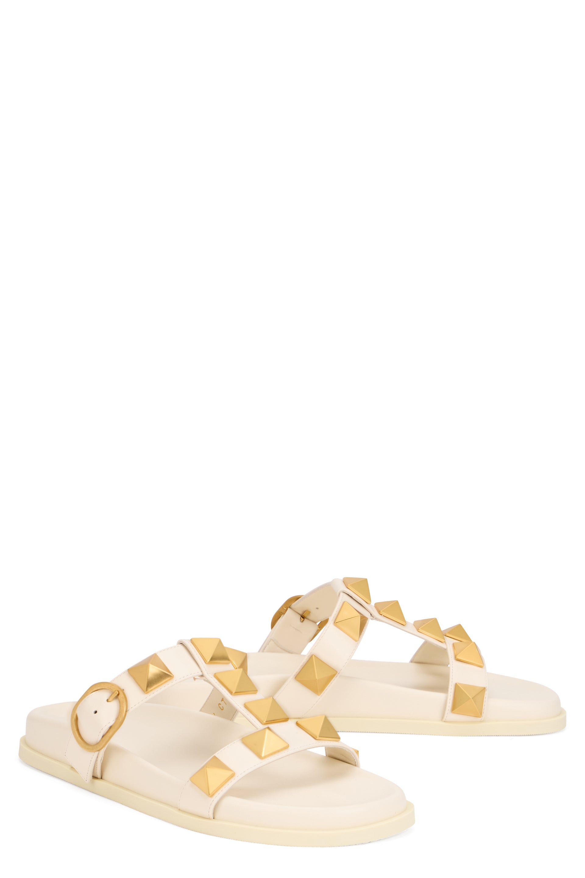 Elegant minimal platform sandals with gold studs.